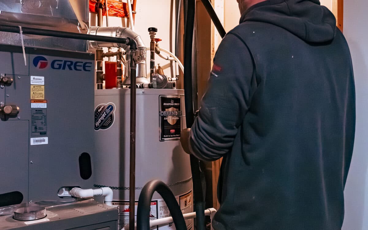 Technician connecting furnace ductwork — Furnace Installation completed in Coquitlam, BC by DirectBuy Furnace