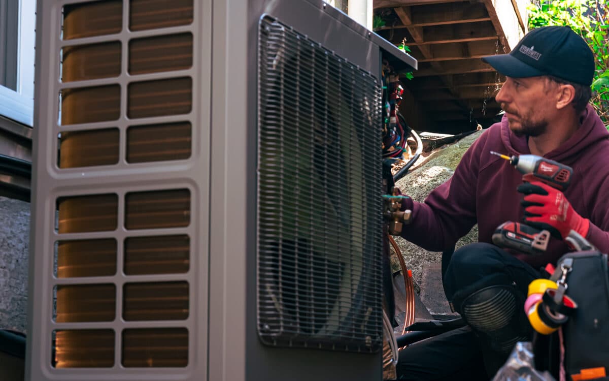 Technician completing an outdoor heat pump install — Heat Pump Installation completed in Coquitlam, BC by DirectBuy Furnace
