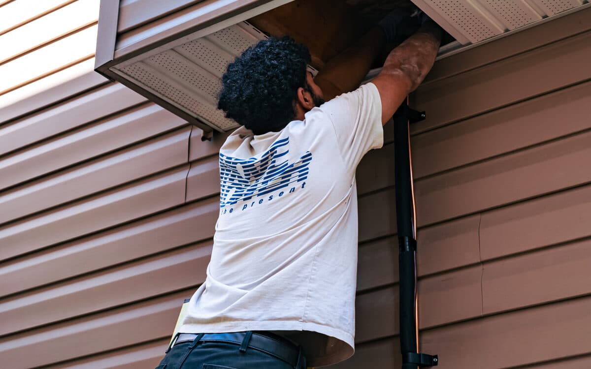 Technician mounting an outdoor heat pump unit — Heat Pump Installation completed in Delta, BC by DirectBuy Furnace